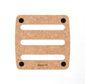 Square epicurean trivet with three horizontal slots and four black non-slip feet, light woodgrain surface.