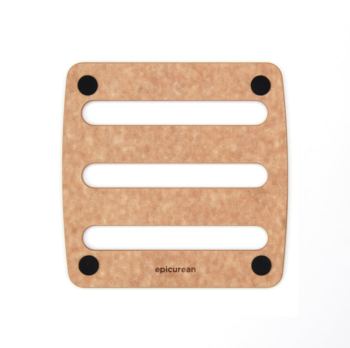Square epicurean trivet with three horizontal slots and four black non-slip feet, light woodgrain surface.