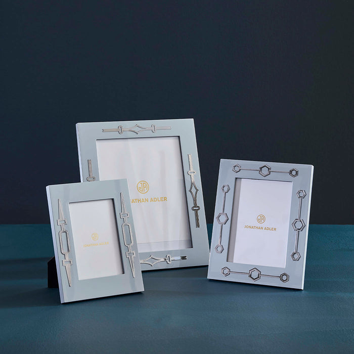 Three decorative photo frames on a dark surface with a dark background