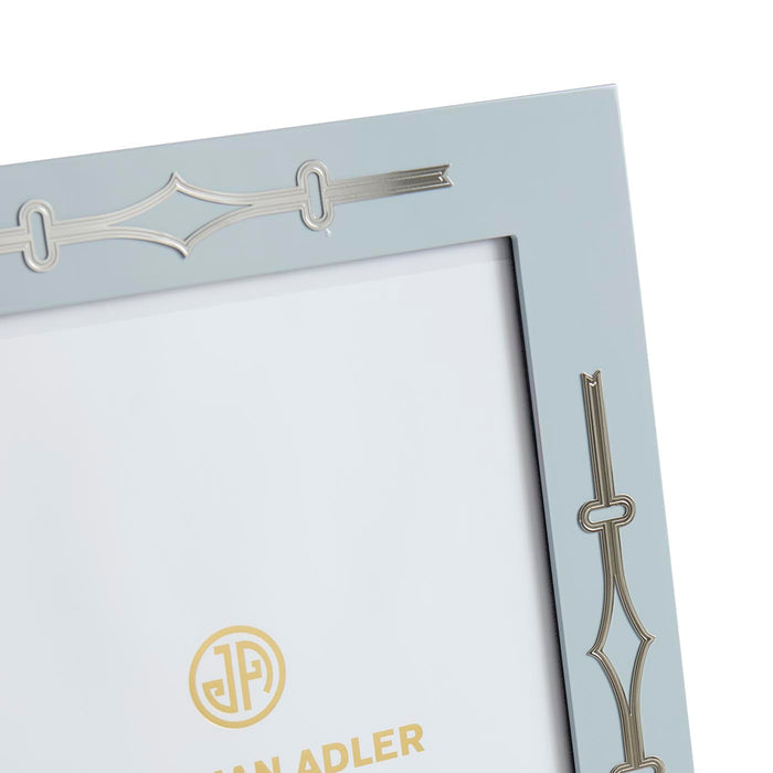 Close-up of a decorative picture frame with intricate designs and a brand logo.