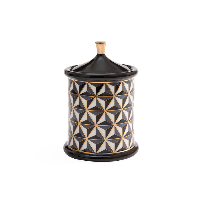 A cylindrical decorative container with a matching lid, featuring a black, white, and gold geometric pattern on the body and a solid black lid and base with a small gold finial on top, set against a plain white background.