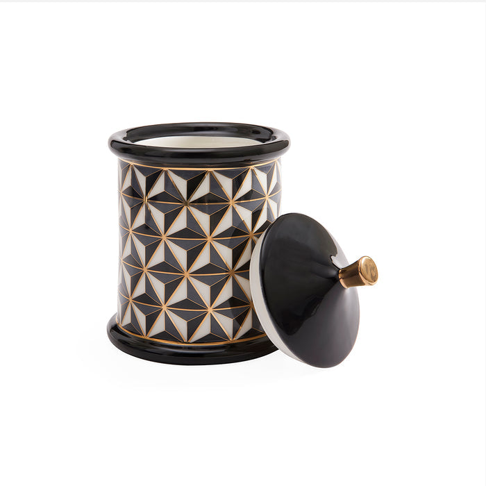 A black and white ceramic jar with a geometric star pattern and a matching black lid resting beside it on a white background.