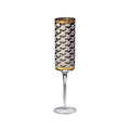 A clear stemmed glass featuring a cylindrical patterned body with a black, white, and gray geometric cube design and gold trim at the top and bottom, shown on a plain white background.