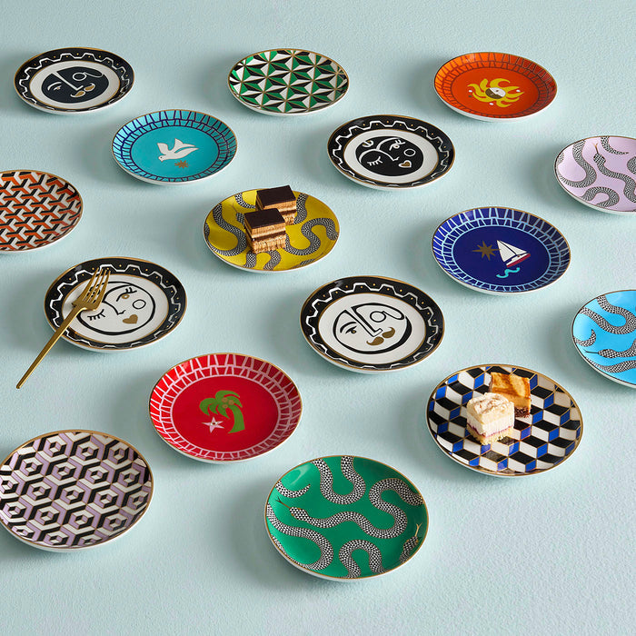 Collection of small decorative plates with various patterns on a light blue background