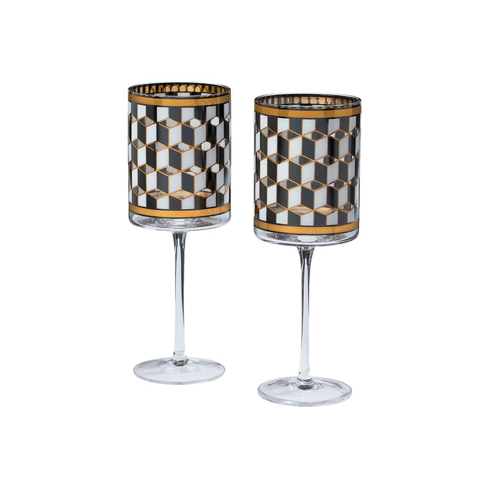 Two clear stemmed glasses with cylindrical bodies featuring a black, white, and gold geometric cube pattern, shown on a plain white background.