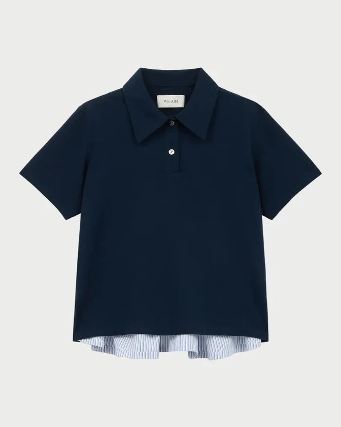 Navy blue polo shirt with a white label on a light gray background