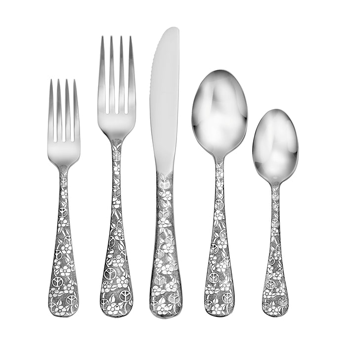 Top view of Woodstock flatware set showing peace-and-flower engraved handles on white background